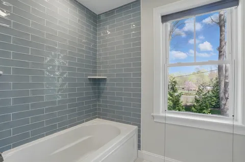 a bathroom with a bathtub and window