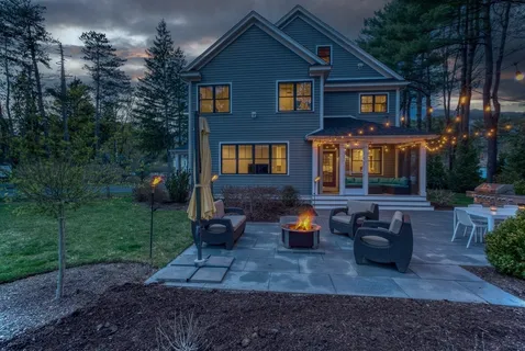 a front view of a house with outdoor seating