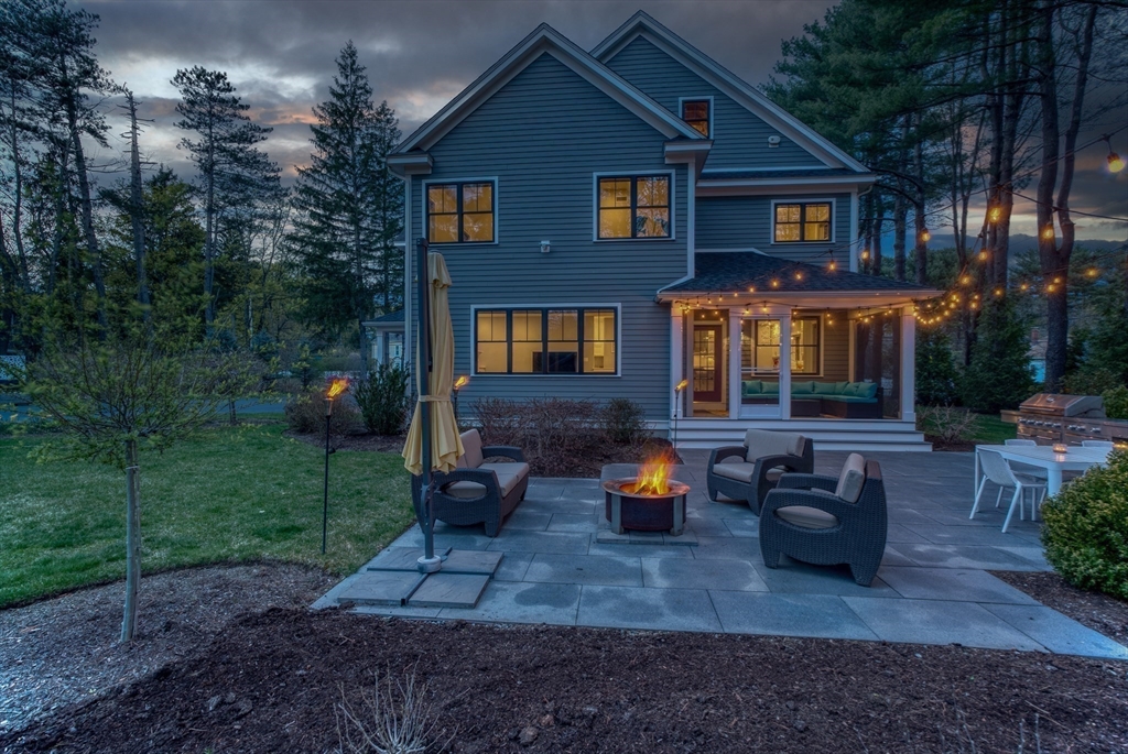 186 Concord Road Bedford, MA 01730 - Photo 27 of 40 a front view of a house with outdoor seating
