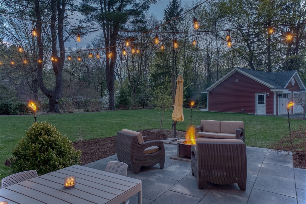 186 Concord Road Bedford, MA 01730 - Photo 28 of 40 a view of a deck with couches fire pit and yard