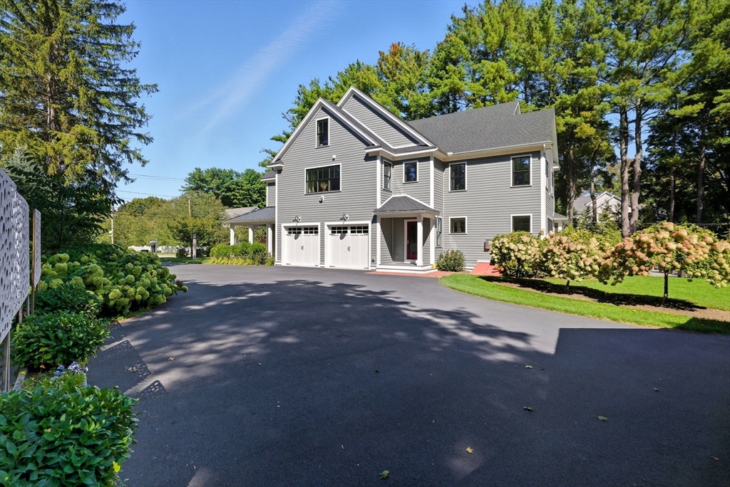 186 Concord Road Bedford, MA 01730 - Photo 33 of 40 a front view of a house with a yard