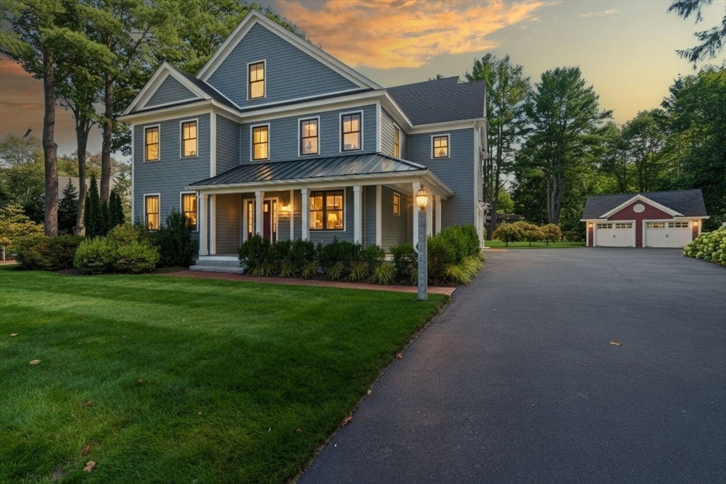 186 Concord Road Bedford, MA 01730 - Photo 40 of 40 a front view of a house with a yard and garage