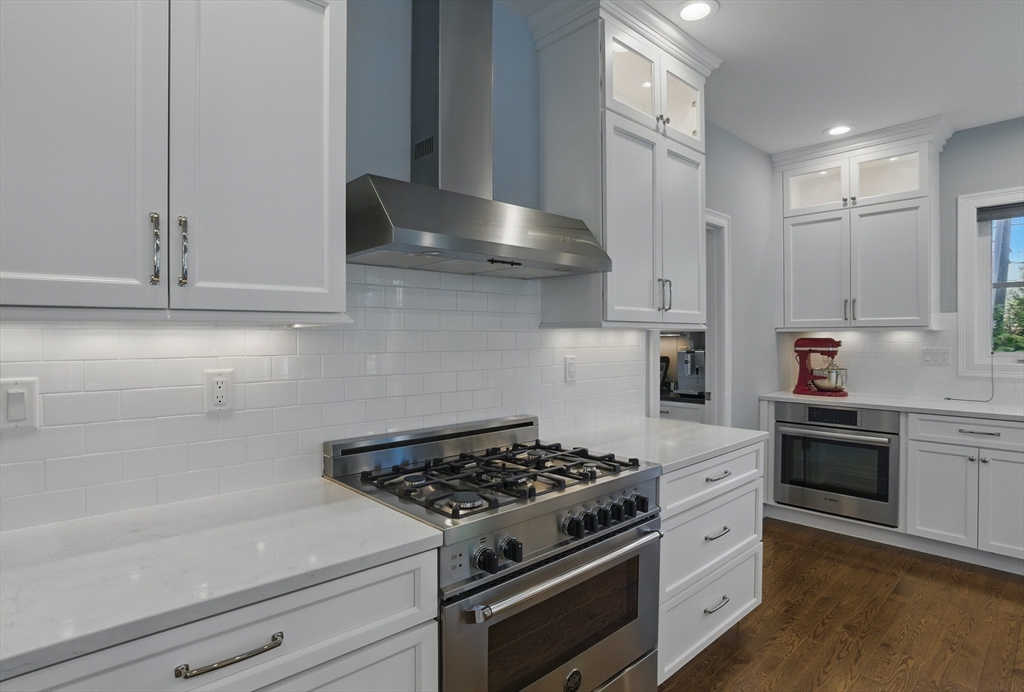 186 Concord Road Bedford, MA 01730 - Photo 5 of 40 a kitchen with stainless steel appliances a stove and white cabinets