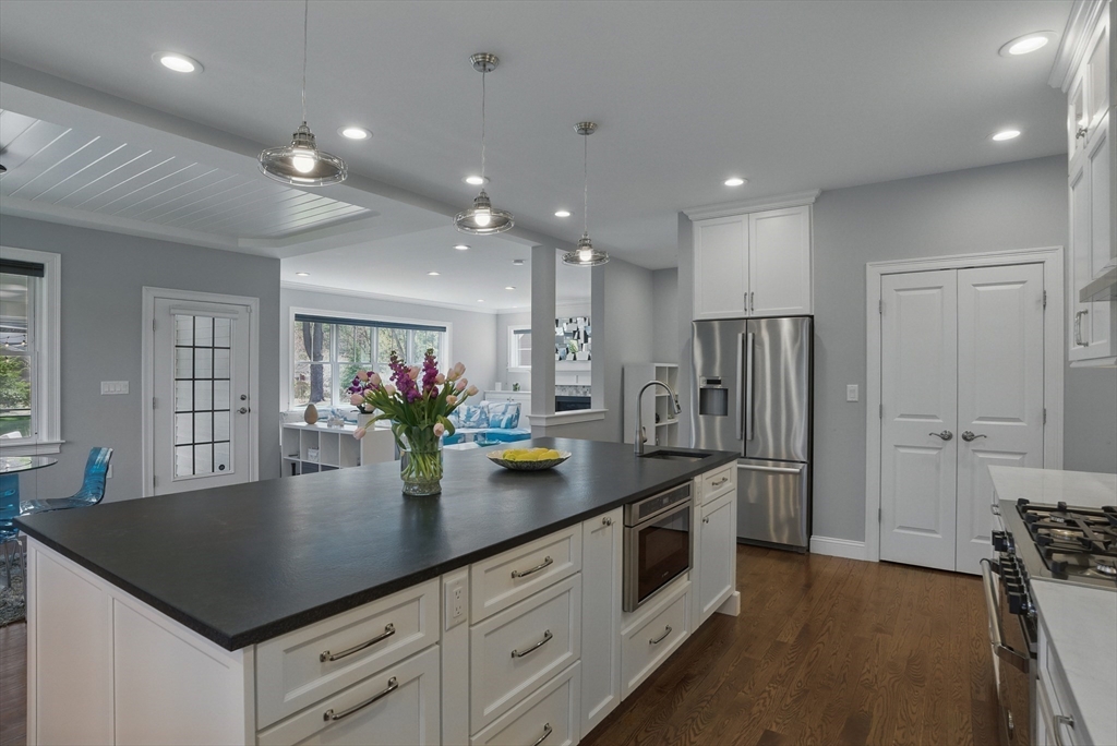 186 Concord Road Bedford, MA 01730 - Photo 6 of 40 a kitchen with stainless steel appliances granite countertop sink refrigerator and dining table
