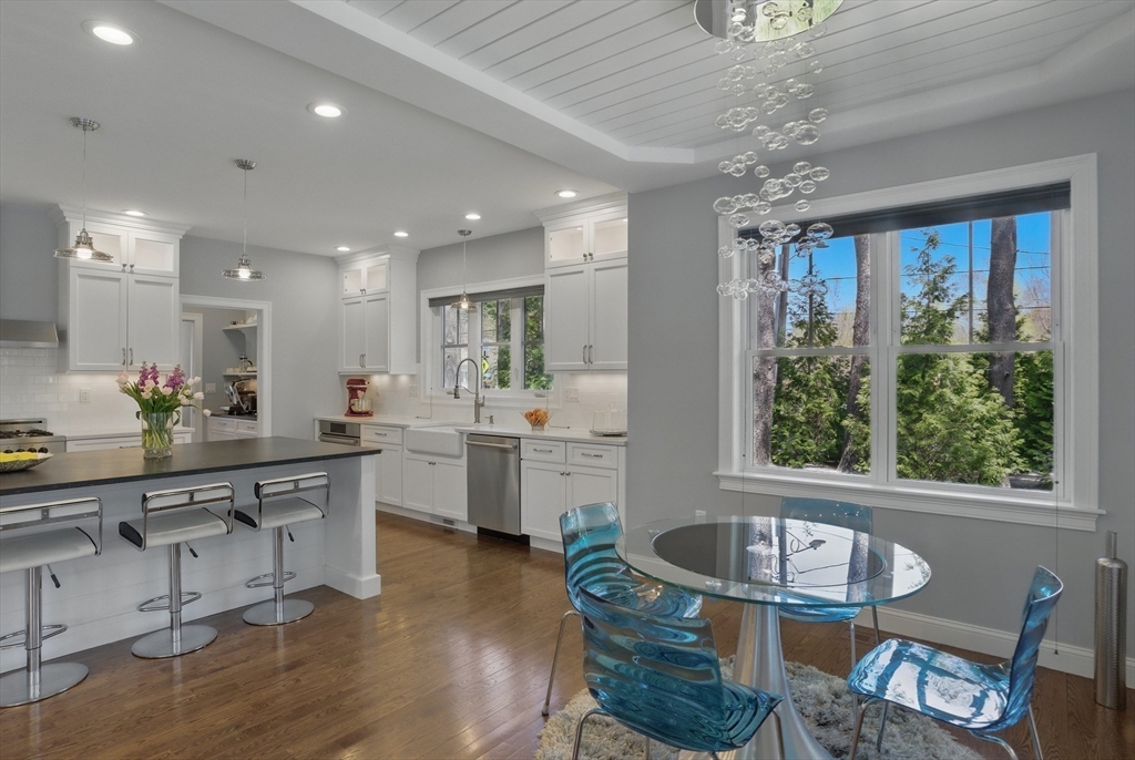 186 Concord Road Bedford, MA 01730 - Photo 7 of 40 a kitchen with sink refrigerator dining table and chairs