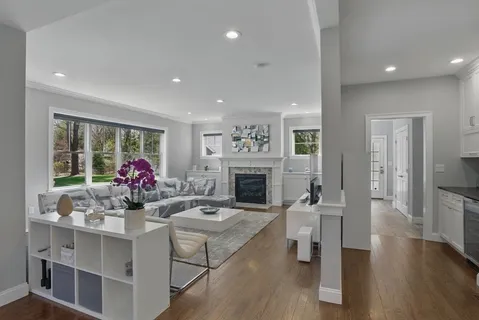 a living room with fireplace furniture and a wooden floor