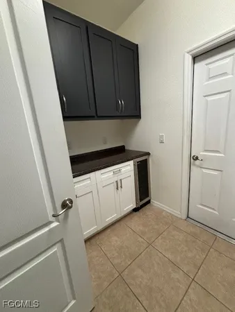 a view of a utility room with cabinets