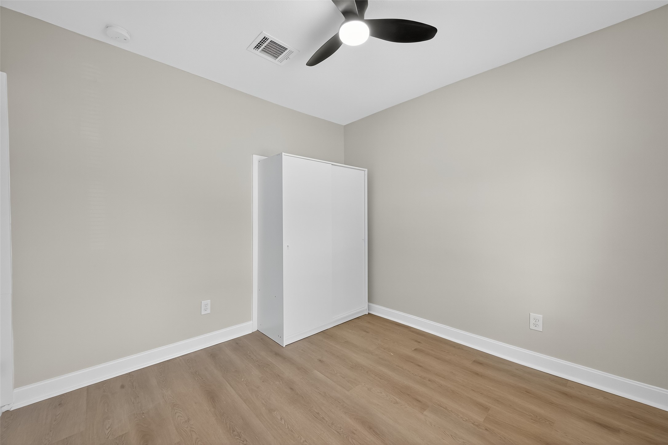889 Chas Lane Houston, TX 77091 - Photo 16 of 32 an empty room with wooden floor and windows
