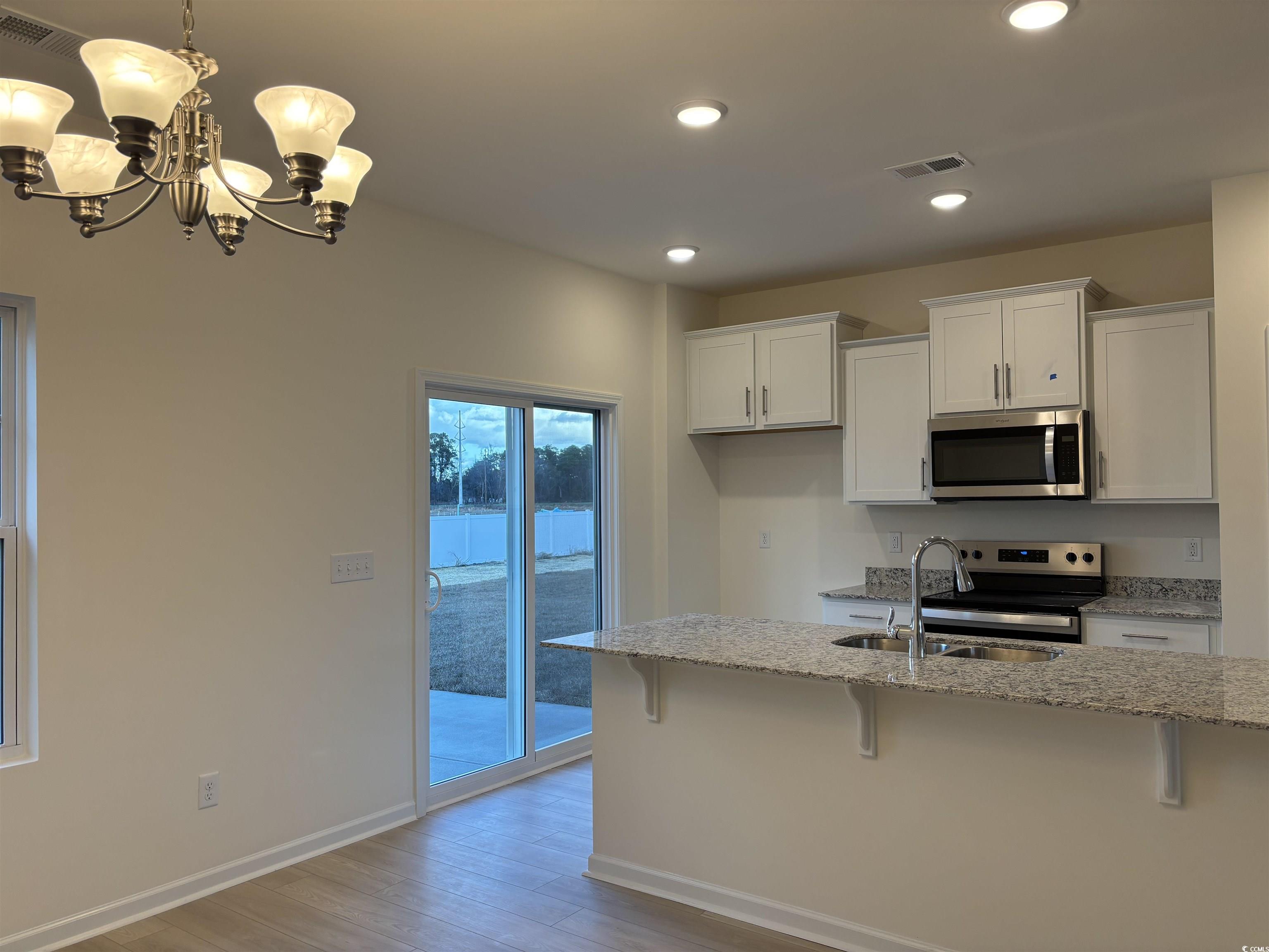 428 Hallie Martin Road Conway, SC 29527 - Photo 6 of 40 Kitchen with white cabinetry, light stone countert