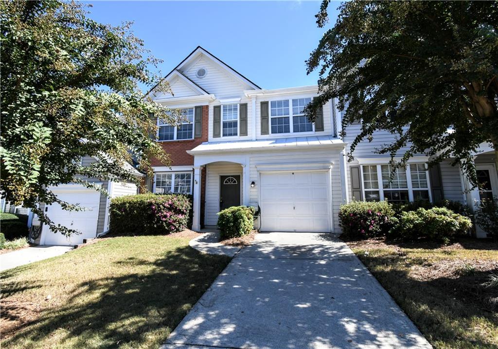 3905 Timbercreek Circle Roswell, GA 30076 - Photo 1 of 30 a front view of a house with a yard and potted plants