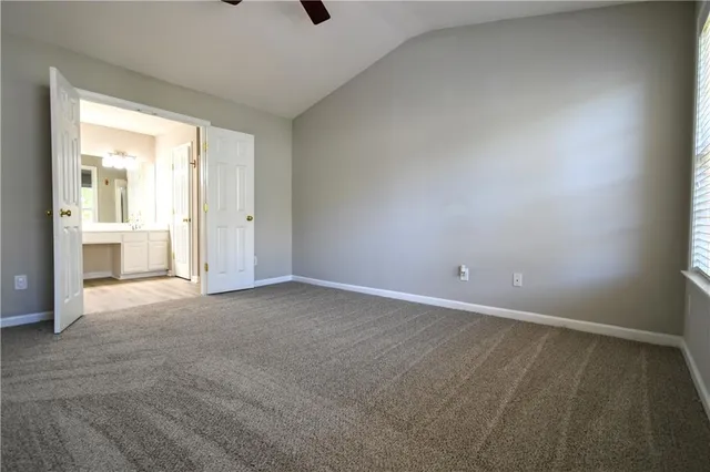 a view of an empty room with a birdcage and a window