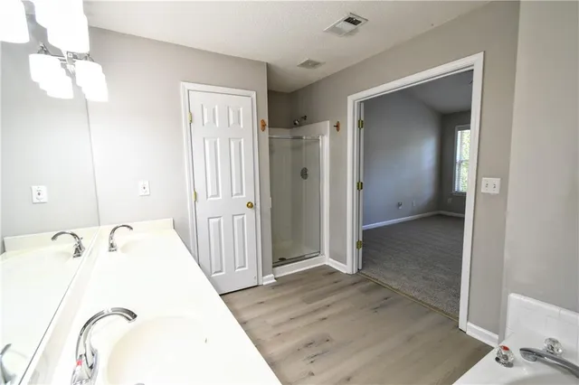 a view of a bathroom with a tub and shower