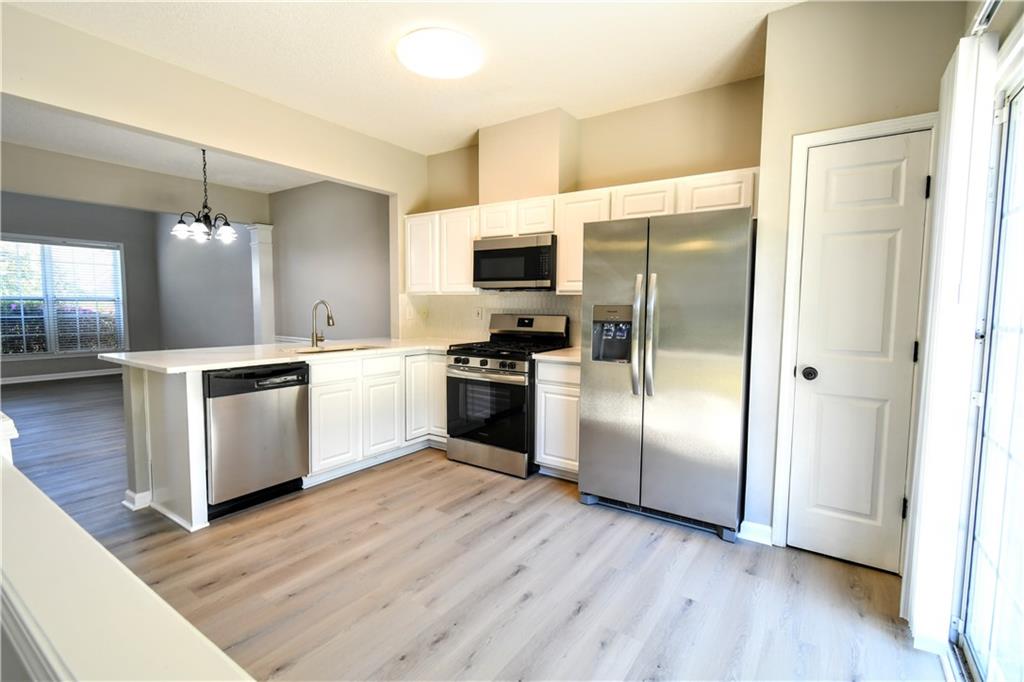 3905 Timbercreek Circle Roswell, GA 30076 - Photo 7 of 30 a kitchen with a refrigerator and a stove top oven
