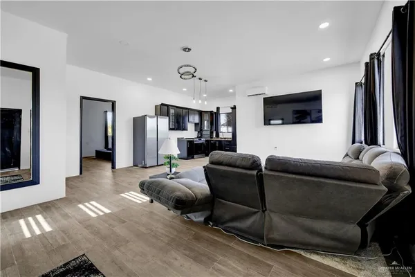 a living room with furniture and a flat screen tv