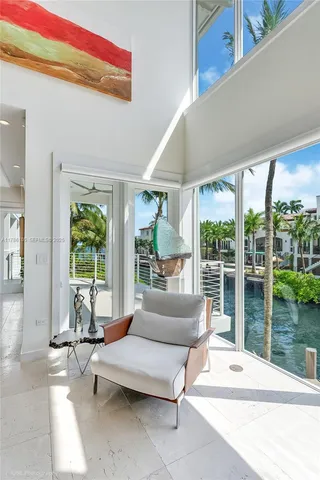 a living room with furniture and a floor to ceiling window