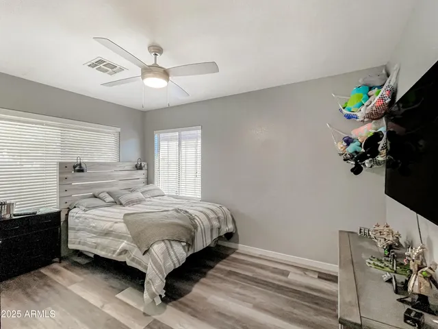 a bedroom with a bed and a potted plant