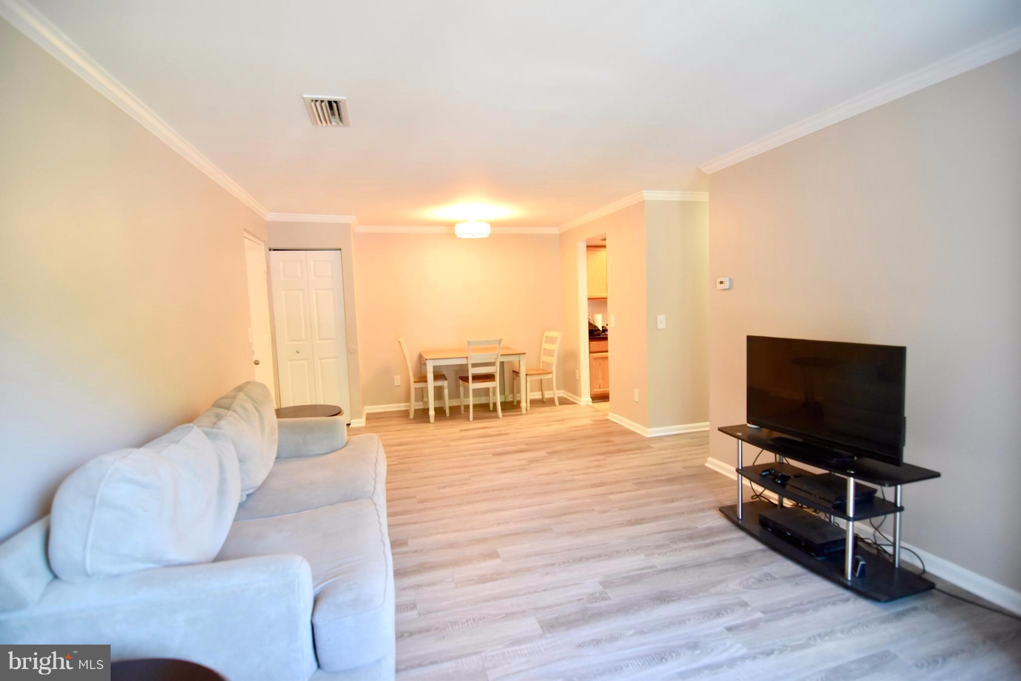 14903 Rydell Road, Unit 204 Centreville, VA 20121 - Photo 2 of 16 a living room with furniture and a flat screen tv