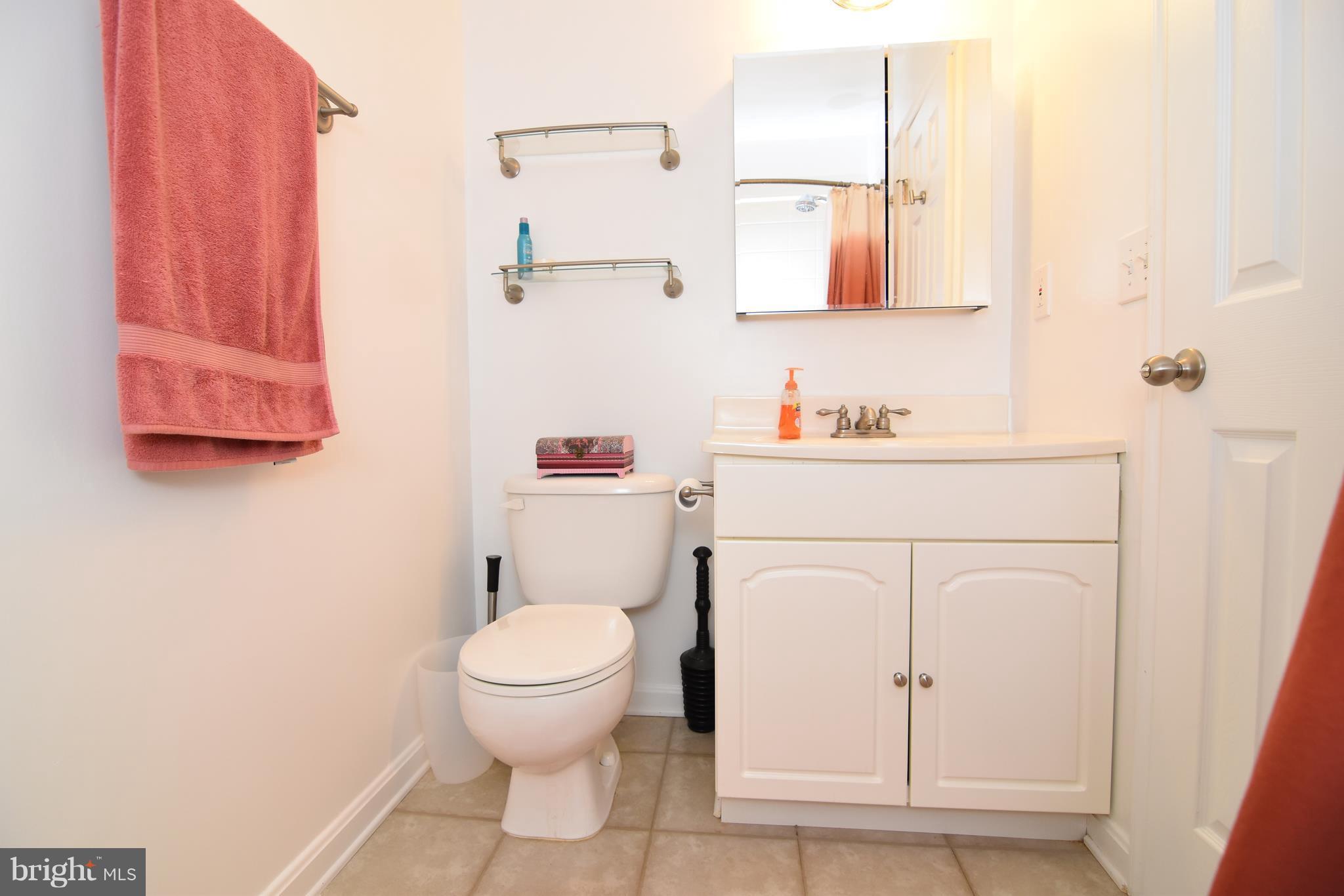 14903 Rydell Road, Unit 204 Centreville, VA 20121 - Photo 9 of 16 a white toilet sitting next to a bathroom sink