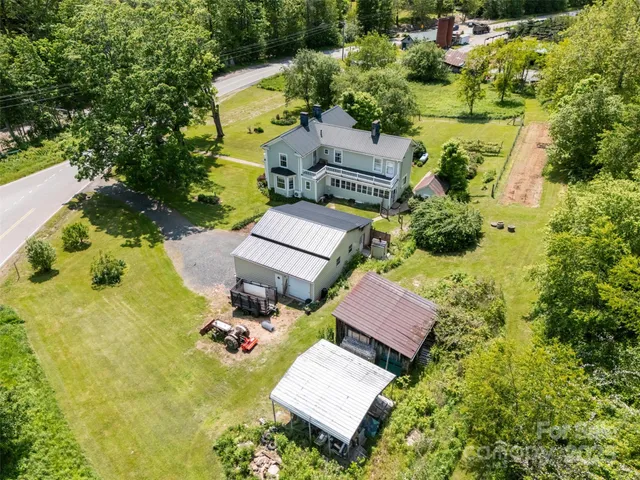 an aerial view of a house with yard swimming pool and outdoor seating