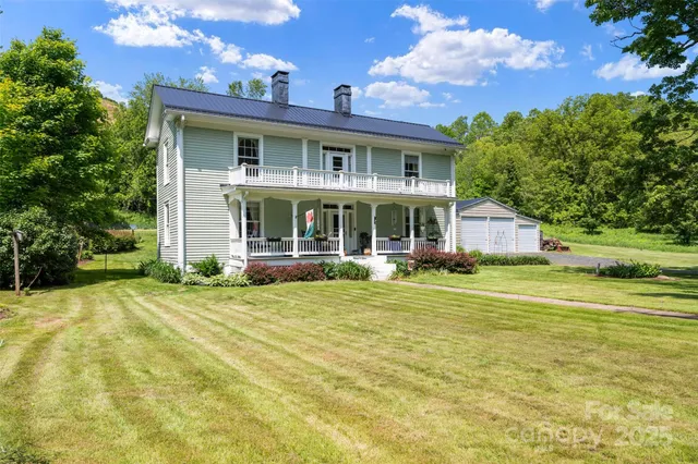 a front view of a house with a yard table and chairs