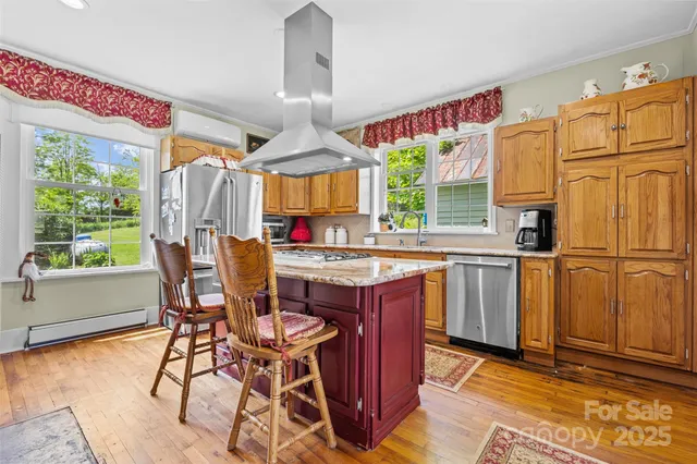 a kitchen with stainless steel appliances granite countertop a stove a refrigerator a sink dishwasher with a dining table and chairs