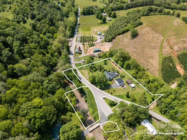 an aerial view of a residential houses with outdoor space and street view