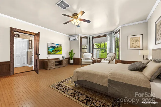 a bedroom with a bed and a chandelier