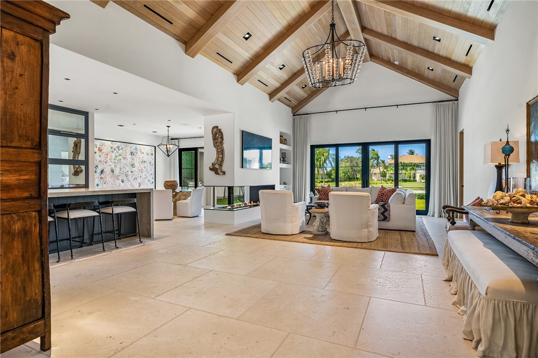 61 Caribe Way Vero Beach, FL 32963 - Photo 11 of 36 a living room with furniture a fireplace and a table