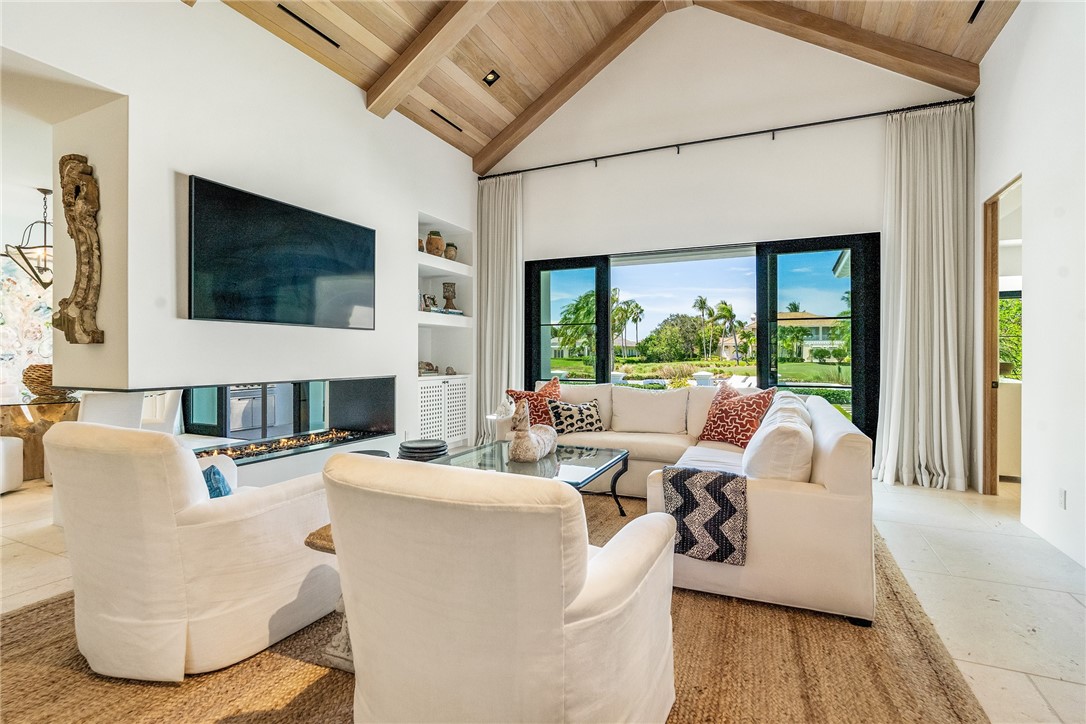61 Caribe Way Vero Beach, FL 32963 - Photo 13 of 36 a living room with fireplace furniture and a flat screen tv