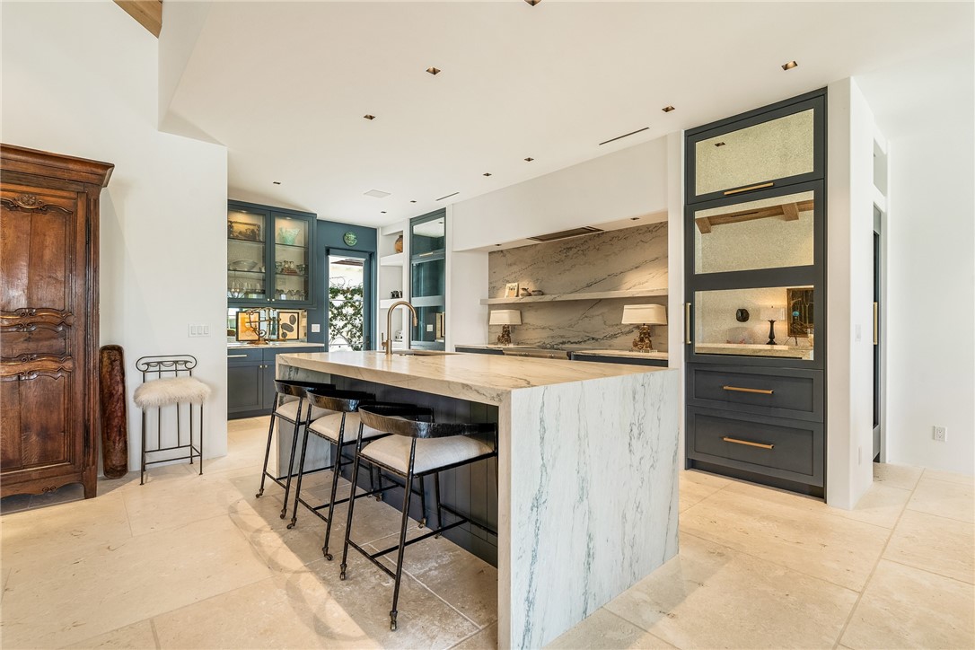 61 Caribe Way Vero Beach, FL 32963 - Photo 16 of 36 a kitchen with a table chairs refrigerator and cabinets
