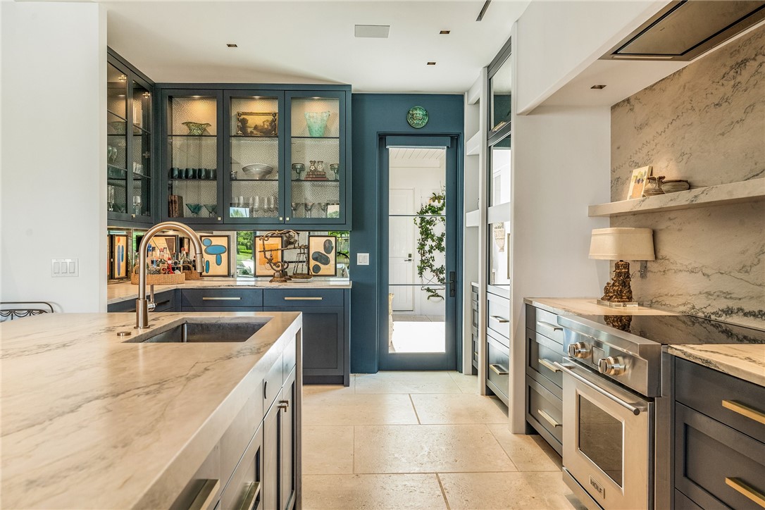 61 Caribe Way Vero Beach, FL 32963 - Photo 17 of 36 a kitchen with a stove a sink and a refrigerator