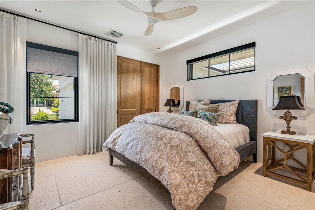 61 Caribe Way Vero Beach, FL 32963 - Photo 20 of 36 a bedroom with a bed and a chandelier