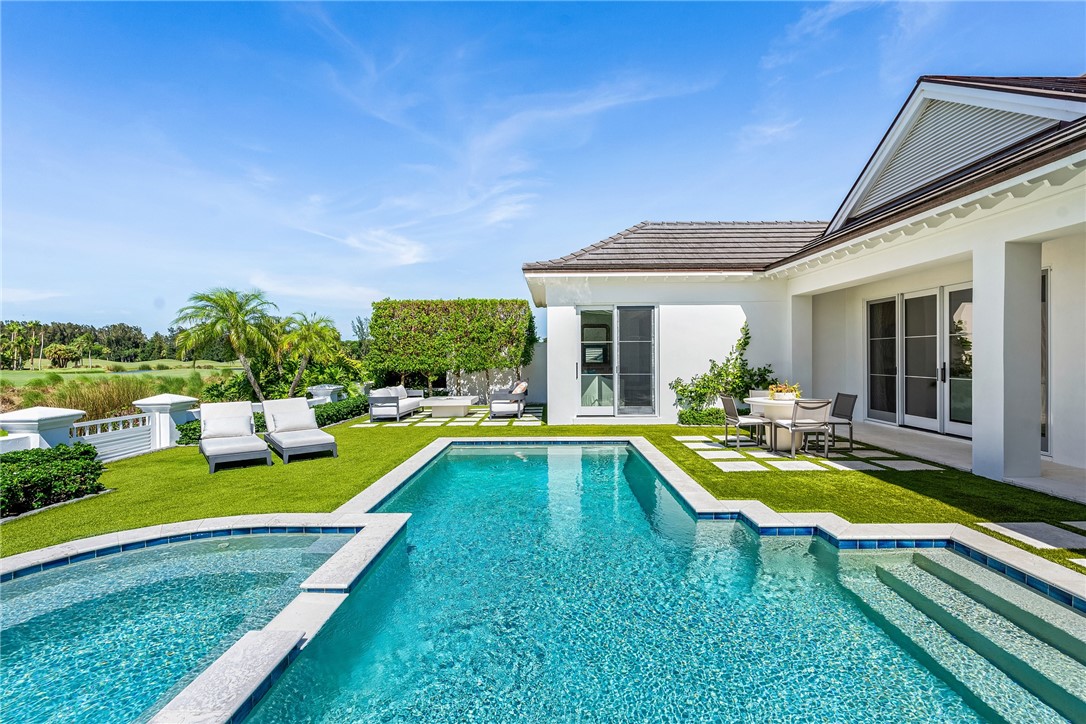 61 Caribe Way Vero Beach, FL 32963 - Photo 2 of 36 a view of a house with swimming pool and a yard