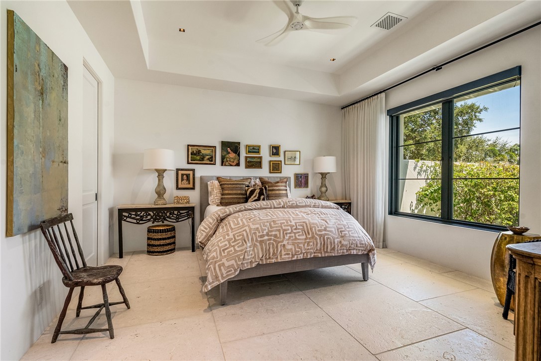 61 Caribe Way Vero Beach, FL 32963 - Photo 22 of 36 a bedroom with a bed furniture and a large window