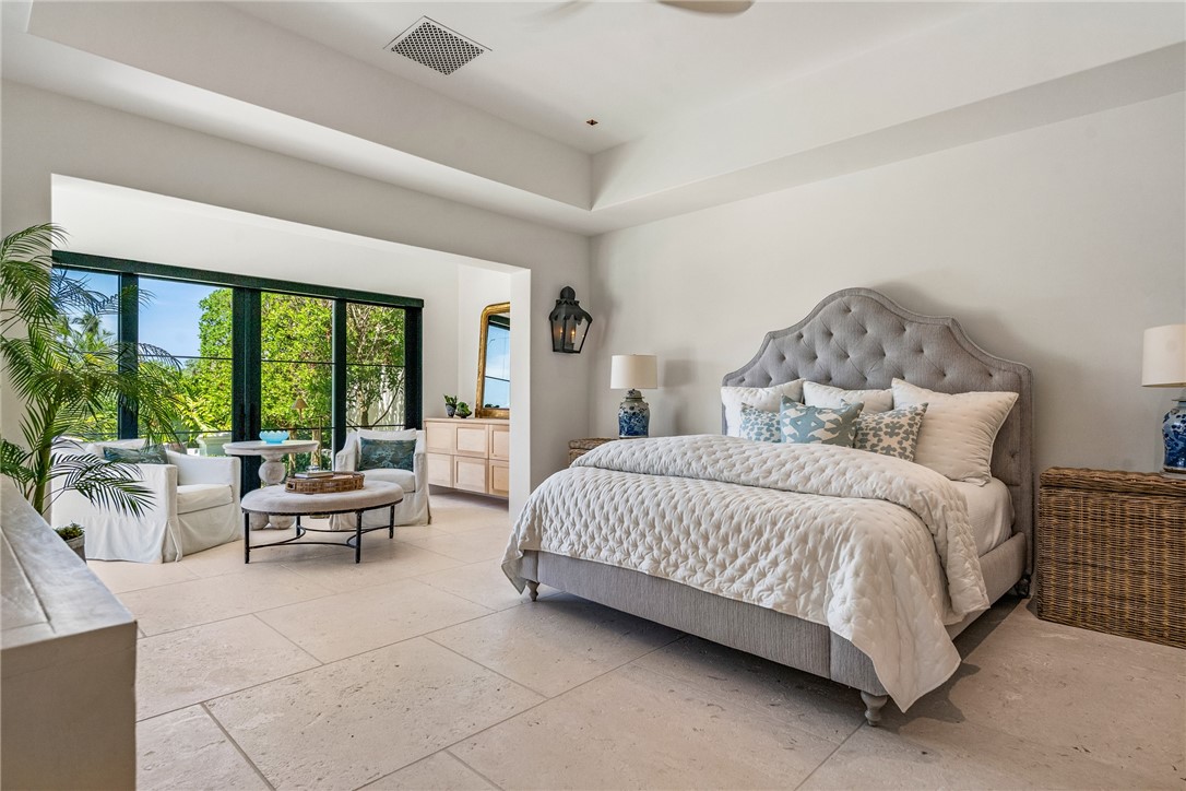 61 Caribe Way Vero Beach, FL 32963 - Photo 23 of 36 a spacious bedroom with a bed and large windows