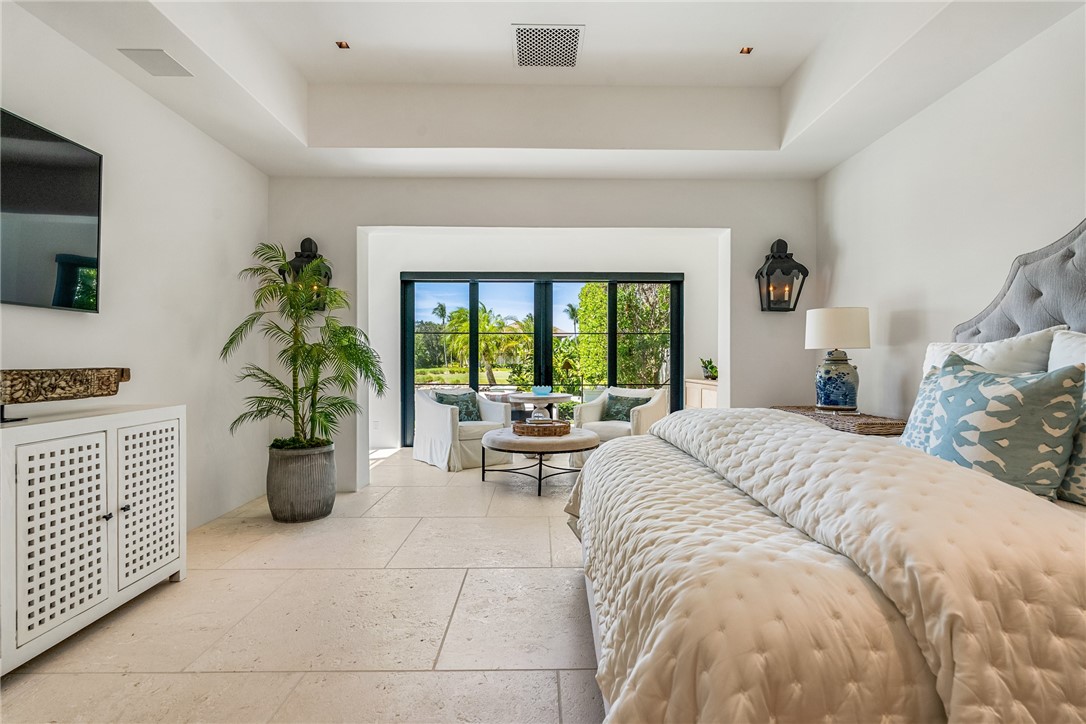 61 Caribe Way Vero Beach, FL 32963 - Photo 24 of 36 a bedroom with a balcony a bed and a couch