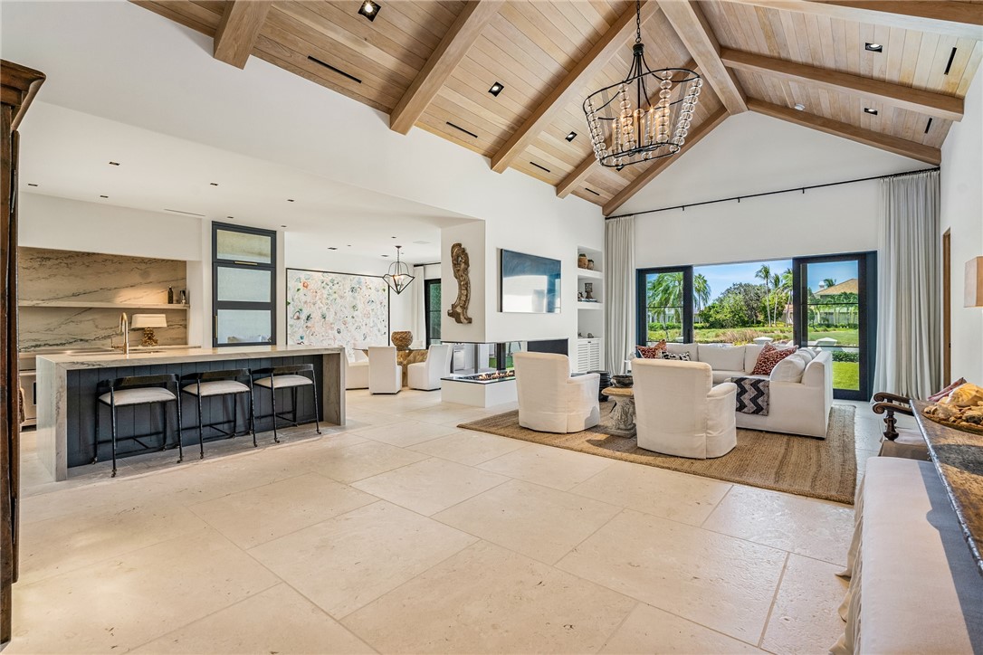 61 Caribe Way Vero Beach, FL 32963 - Photo 4 of 36 a living room with furniture a fireplace and flat screen tv