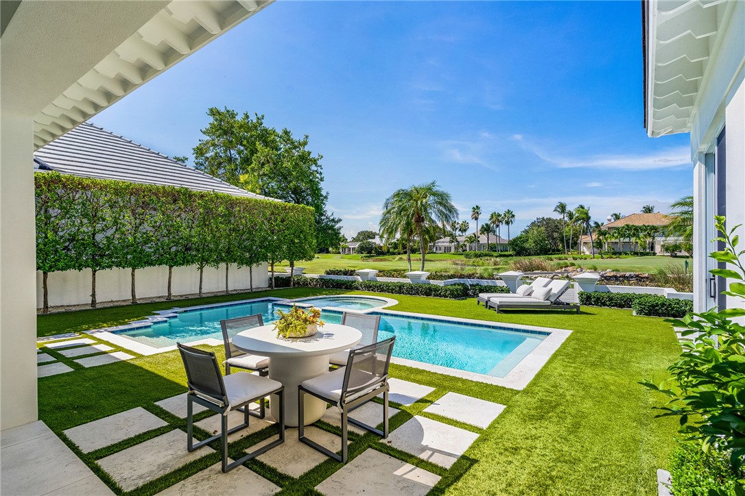 61 Caribe Way Vero Beach, FL 32963 - Photo 8 of 36 a view of swimming pool with outdoor seating and yard
