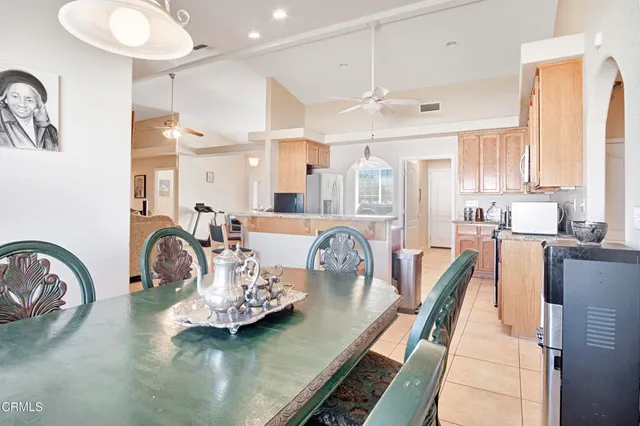 a dining room with furniture and a large window