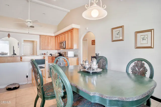 a dining room with furniture and a chandelier