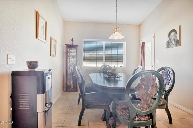 a dining room with furniture a chandelier and wooden floor