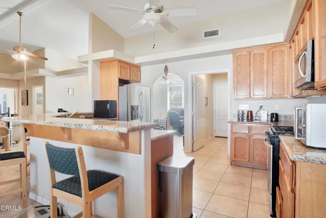 a large kitchen with kitchen island granite countertop lots of counter top space