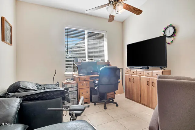 a view of a livingroom with workspace and a window