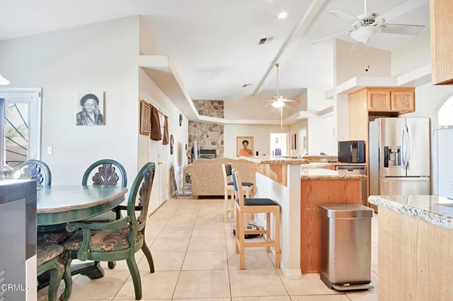 a dining room with furniture and a kitchen view
