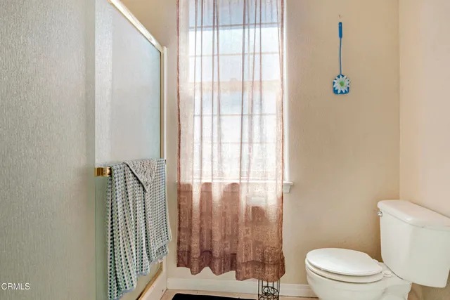 a bathroom with a toilet and a shower