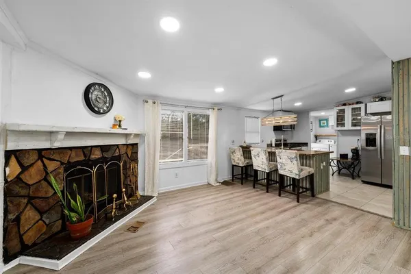 a view of a kitchen with furniture and a fireplace