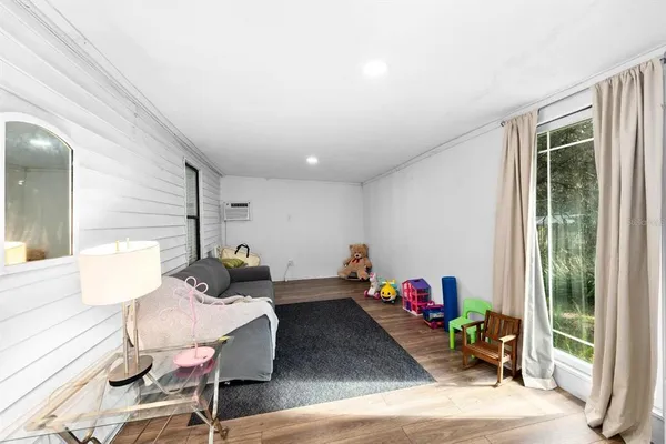 a living room with furniture toys and a large window