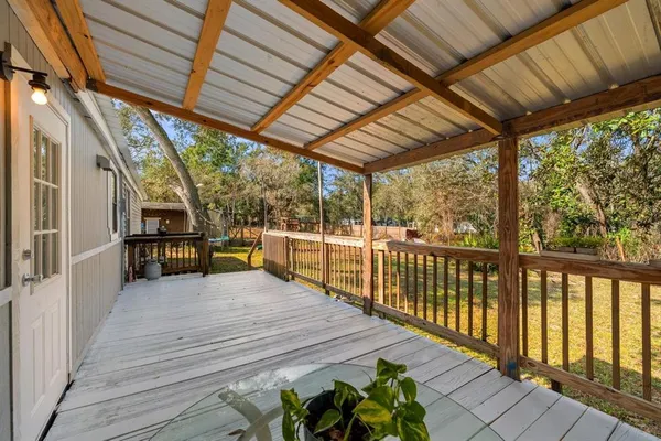a view of a balcony with wooden floor