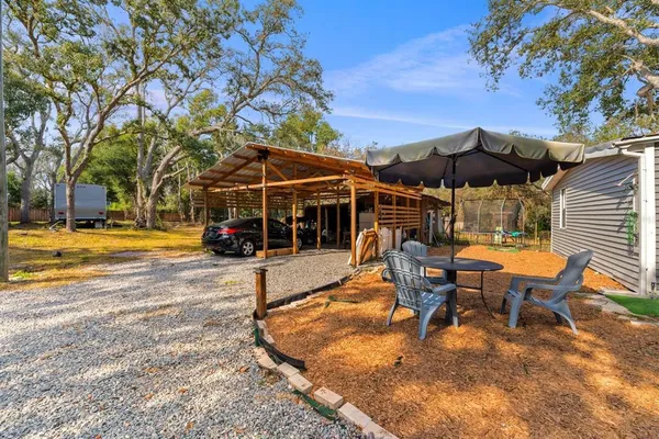 an aerial view of residential house with space and trees all around