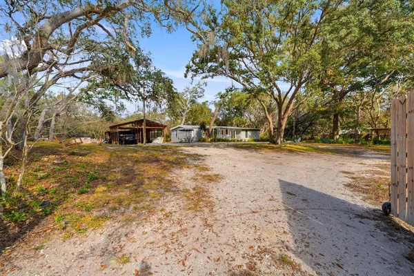 a view of a yard with wooden fence